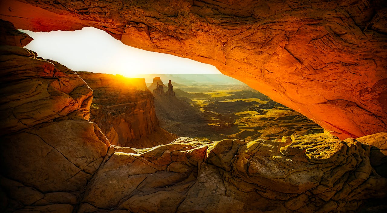 services-03 Captivating view of sunrise through Mesa Arch, showcasing breathtaking rock formations and desert landscape.